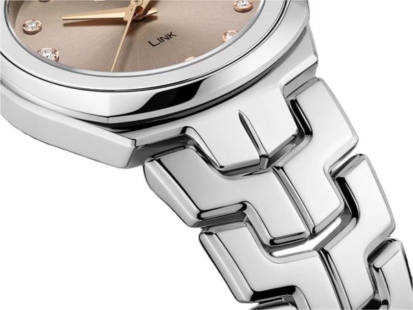 Ladies TAG Heuer Stainless Steel Diamond Set Link Quartz Watch. The 32mm case and bracelet are stainless steel. The dial is taupe in colour with 12 diamond set hour markers and a date function. The glass is sapphire crystal and the watch is 100m water resistant. The movement is quartz. 