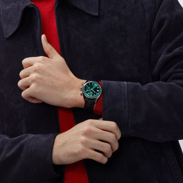CBS2211.FC6545
 TAG Heuer Carrera Chronograph Automatic Watch. The 39mm case is stainless steel with a black alligator strap and deployment clasp. The watch features a chronograph function. The dial is circular brushed teal green with one minute counter sub-dial at 3 o'clock and date function at 9 o'clock.