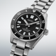 Gent's Seiko Prospex 1965 Heritage Divers 300m Automatic Watch. The 40mm case and bracelet are stainless steel. The bezel and dial are black. The glass is sapphire crystal. The watch has a date function and is 300m water resistant. The movement is automatic