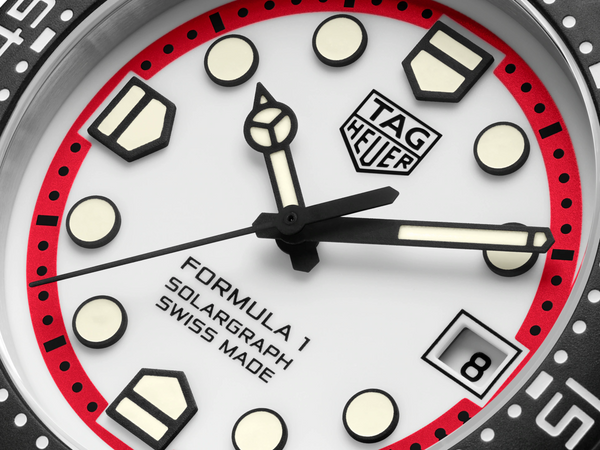 Close-up of a Tag Heuer watch face with red and black accents.