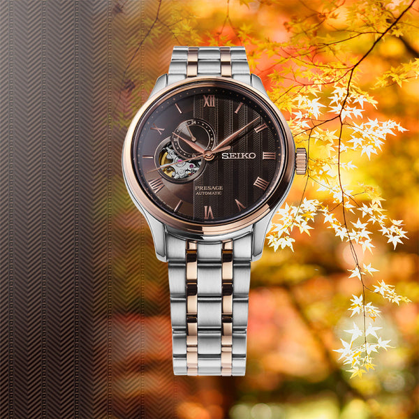 Seiko watch with two-tone metal strap on gray backgroundGents Seiko Presage Japanese Garden Automatic Watch. The 41.8mm case and bracelet are bicolour: rose gold PVD and stainless steel. The dial is black with a textured pattern, rose coloured roman numerals and hands, 24-hour indicator sub-dial and circular shaped movement window. The watch has a sapphire crystal glass with a see-through case back. The movement is automatic. MODEL SSA466J