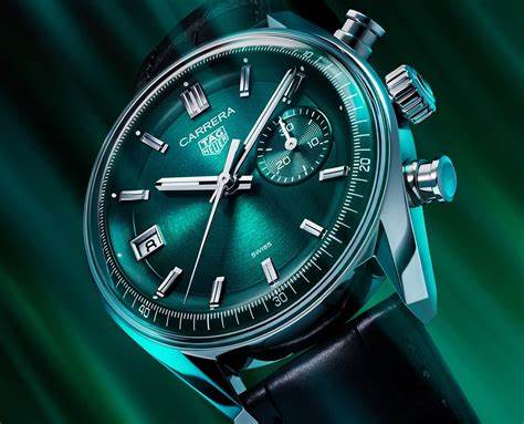 CBS2211.FC6545
 TAG Heuer Carrera Chronograph Automatic Watch. The 39mm case is stainless steel with a black alligator strap and deployment clasp. The watch features a chronograph function. The dial is circular brushed teal green with one minute counter sub-dial at 3 o'clock and date function at 9 o'clock.