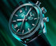 CBS2211.FC6545
 TAG Heuer Carrera Chronograph Automatic Watch. The 39mm case is stainless steel with a black alligator strap and deployment clasp. The watch features a chronograph function. The dial is circular brushed teal green with one minute counter sub-dial at 3 o'clock and date function at 9 o'clock.