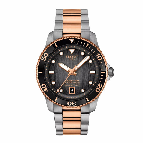 Tissot watch with rose gold and silver band on white background