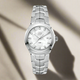 A stainless steel TAG Heuer Link quartz watch with a white mother-of-pearl dial, diamond hour markers, and a date function.
