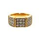A yellow gold ring featuring three square pavé sections set with clear gemstones, photographed on a clean white background with a soft reflection.
