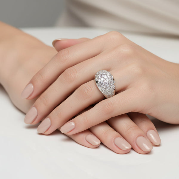 Silver ring with diamond cluster on a white background