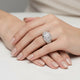 Silver ring with diamond cluster on a white background