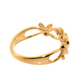 A gold ring with a decorative filigree band and a small clear gemstone, shown on a plain white background.