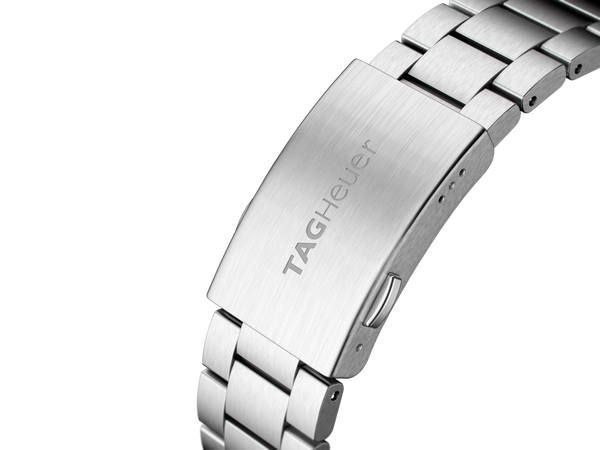 Close-up of a silver watch band with 'TAG Heuer' branding on a white background