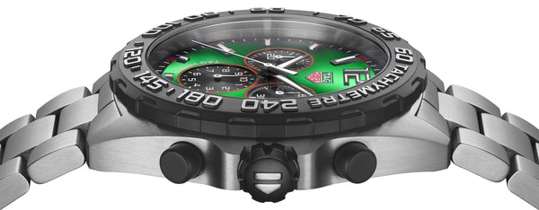 Silver watch with a green face on a white background