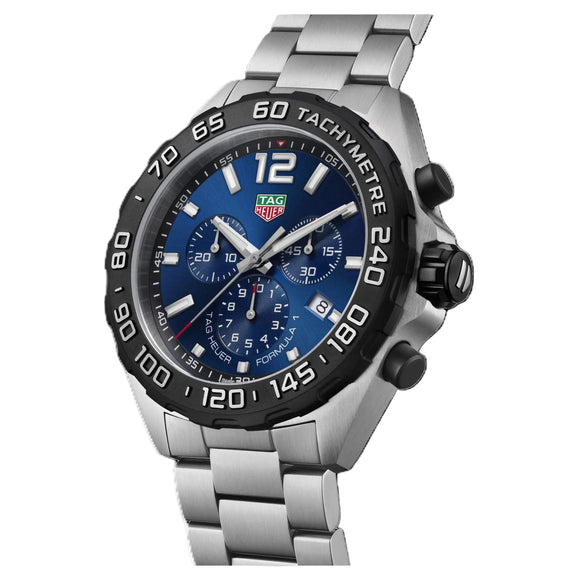 TAG Heuer wristwatch with a stainless steel link bracelet, featuring a blue dial, black tachymeter bezel, and silver-tone case on a white background.