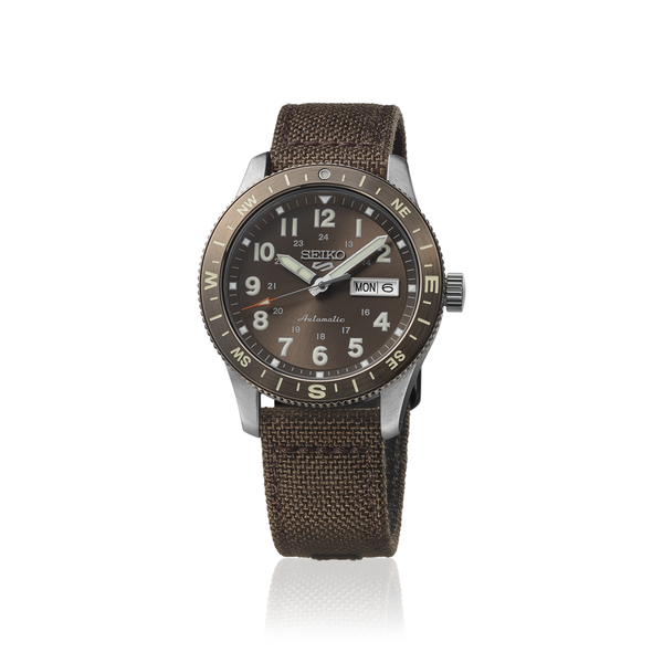 Gent's Seiko 5 Sports Field Series Automatic Watch.

Model Number: HDB009K

Availability: in stock

The 41mm case is stainless steel with a brown nylon strap. The bezel is brown with compass indicators. The dial is brown with a day / date function. The watch has a see-through case back and is 100m water resistant. The movement is automatic.