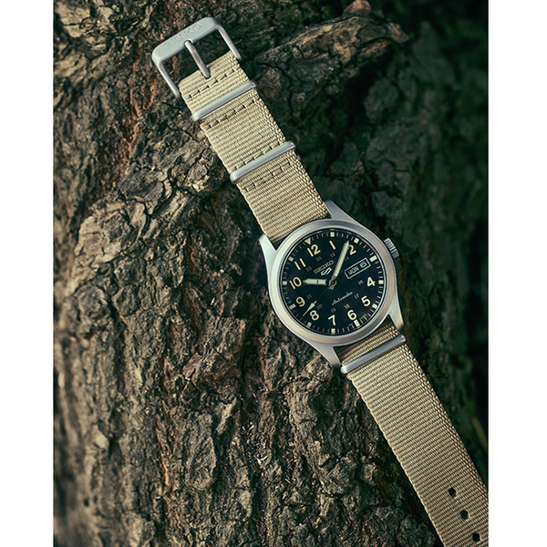 Gent's Seiko 5 Sports Field Series Automatic Watch.
Model Number: SRPG35K
The 39.4mm case is stainless steel with a beige nylon strap. The dial is black with 24-hour markers and a day / date function. The watch has a see-through case back and is 100m water resistant. The movement is automatic.