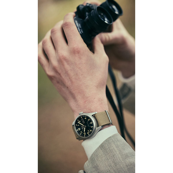 Gent's Seiko 5 Sports Field Series Automatic Watch.
Model Number: SRPG35K
The 39.4mm case is stainless steel with a beige nylon strap. The dial is black with 24-hour markers and a day / date function. The watch has a see-through case back and is 100m water resistant. The movement is automatic.