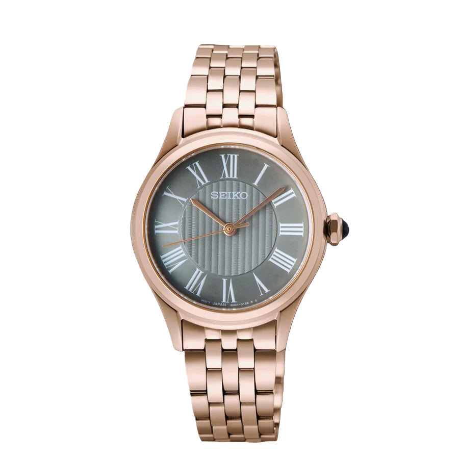 Rose gold Seiko watch with a dark face on a black background