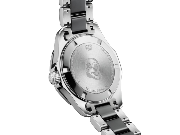 Ladies' TAG Heuer Aquaracer 35mm Watch. The case and bracelet are bicolour stainless steel and black ceramic links/bezel, the dial is black and the glass is sapphire crystal. The watch features a diamond set dial and date function. The watch is 300 metres water resistant and the movement is quartz. 