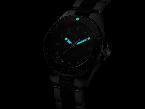 Ladies' TAG Heuer Aquaracer 35mm Watch. The case and bracelet are bicolour stainless steel and black ceramic links/bezel, the dial is black and the glass is sapphire crystal. The watch features a diamond set dial and date function. The watch is 300 metres water resistant and the movement is quartz. 