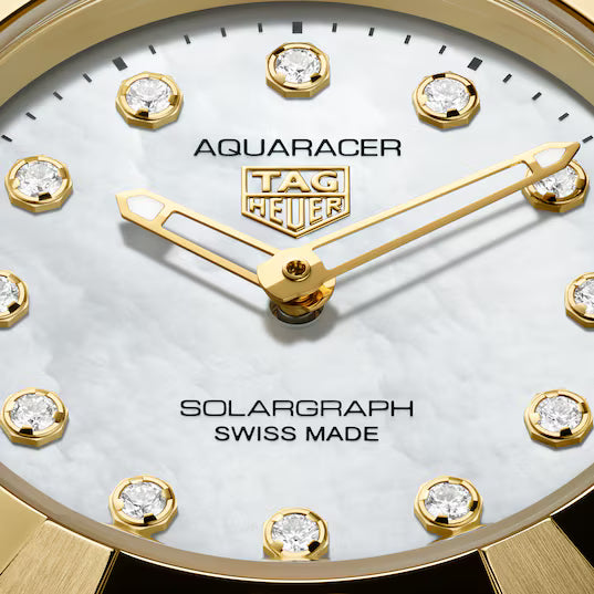 Ladies' TAG Heuer Aquaracer Professional 100 Solargraph Watch. The 28mm case and bracelet are bicolour: stainless steel and 18k yellow gold plated bezel and bracelet links. The dial is white mother-of-pearl with twelve diamond set hour markers (0.07ct, Colour G+, Clarity VS+). The glass is sapphire crystal. The watch is 100 metres water resistant. The movement is a CalibreTH51-00 solar quartz. MODEL WBP1422.BB0006