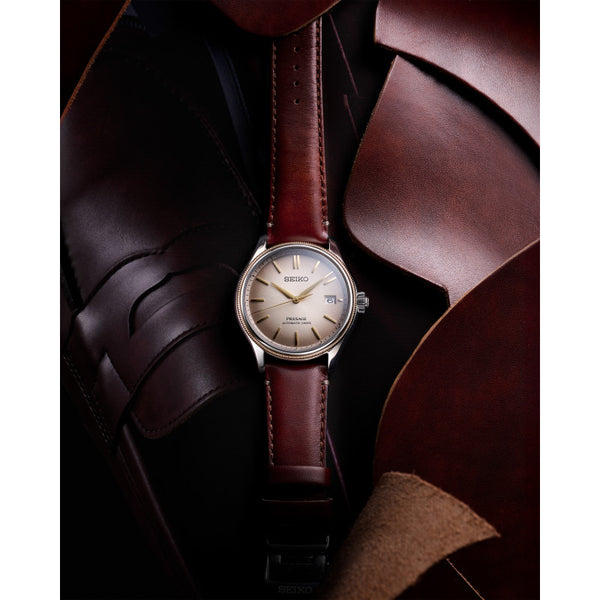 Gents Seiko Presage Classic Automatic Watch. The 40.2mm case and bracelet are stainless steel. The dial is blue with a textured pattern, 24-hour scale sub-dial and circlular shaped movement window. The watch has a curved sapphire crystal glass with a see-through case back and is 100m water resistant. The movement is automatic with a 3-day power reserve.&nbsp;