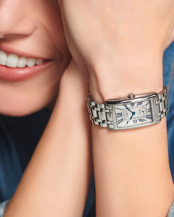 Silver watch on a wrist with a blurred background
