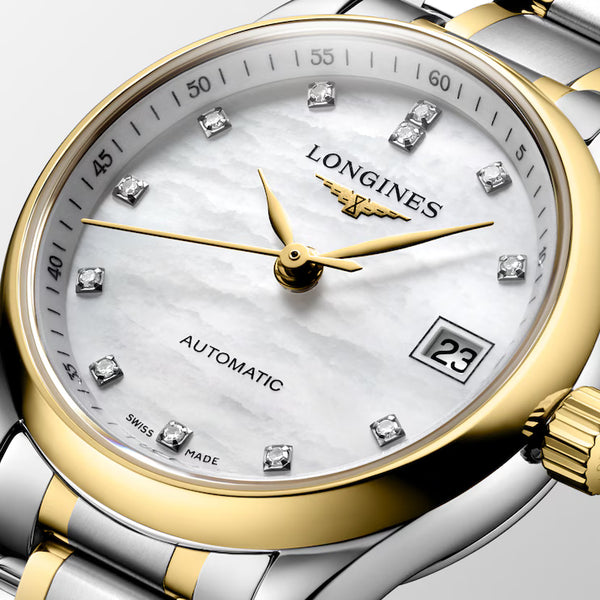 Ladies' Longines Master Collection Automatic Watch. The 25.5mm case and bracelet are bicolour: stainless steel with 18k yellow gold capped bezel and capped centre links. The dial is white mother-of-pearl with twelve diamond set hour markers and a date function. The glass is sapphire crystal and the case back is transparent sapphire crystal &nbsp;glass. The movement is automatic.