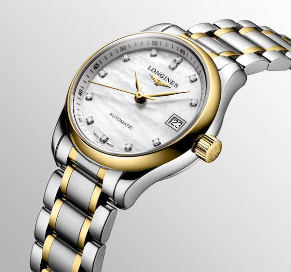 Ladies' Longines Master Collection Automatic Watch. The 25.5mm case and bracelet are bicolour: stainless steel with 18k yellow gold capped bezel and capped centre links. The dial is white mother-of-pearl with twelve diamond set hour markers and a date function. The glass is sapphire crystal and the case back is transparent sapphire crystal glass. The movement is automatic.