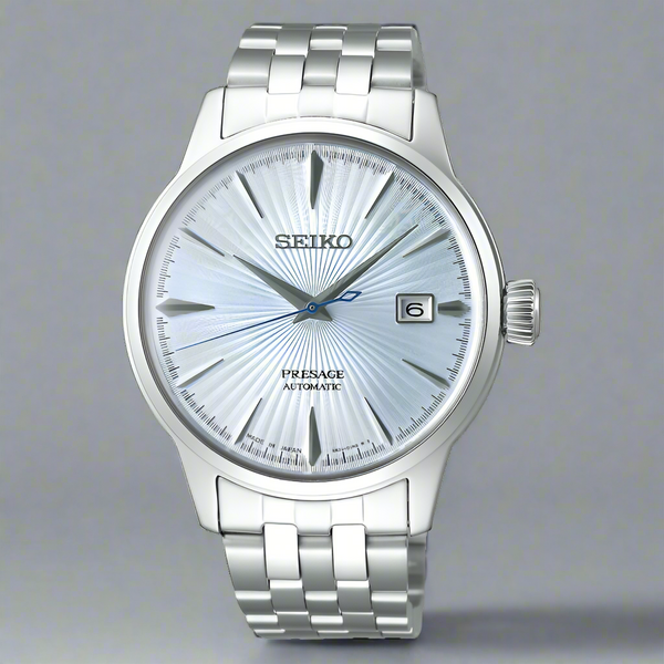 Silver Seiko watch with a white face on a white background