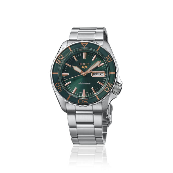 Gent's Seiko 5 Sports SKX Series Automatic Watch.

Model Number: HDB005K

Availability: in stock

The 42.5mm case and bracelet are stainless steel. The bezel is green. The dial is green with rose coloured hands and indexes and a day/date function. The watch has a see-through case back and is 100m water resistant. The movement is automatic.