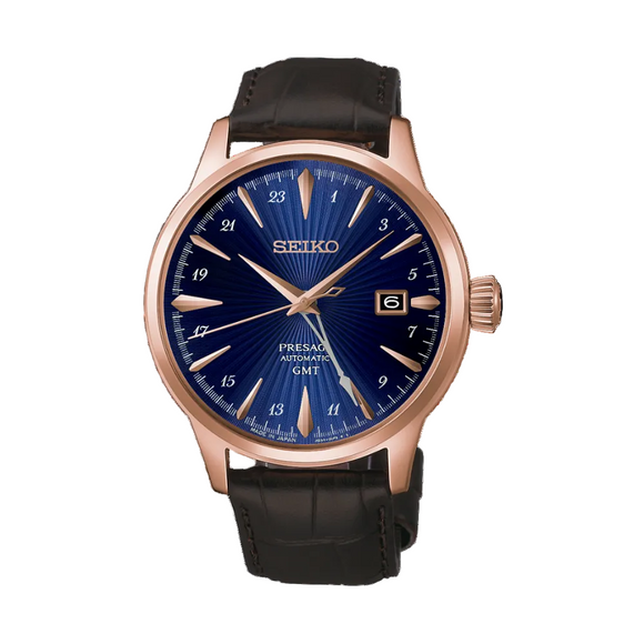 Gent's Seiko Presage Cocktail Time GMT Automatic Watch.

Model: HCB005J

Availability: in stock

The 40.5mm case is rose gold PVD on stainless steel with a brown leather strap and deployment clasp. The radial patterned dial is blue with rose coloured hands and indexes. The watch has a GMT hand for setting on a second time zone, 24-hour indicators and a date function. The watch has a see-through case back. The movement is automatic.